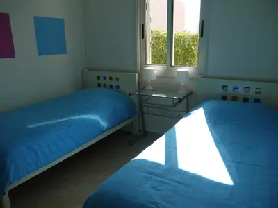 a bedroom with two beds and a window at Sunny Garden Limassol Star in Limassol