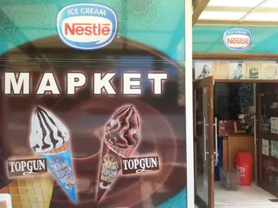 a sign on the front of a store with a sign for a chocolate ice cream at Sunny Garden Limassol Star in Limassol