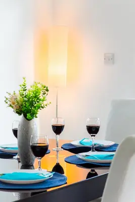 a table with three glasses of wine on it at Villa Palm Breeze by Ezoria Villas in Protaras