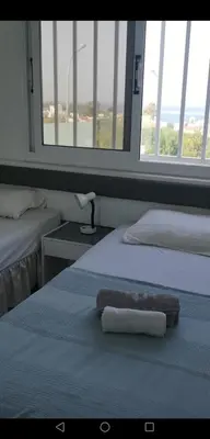 a hotel room with two beds with towels on them at Green Bay Penthouse 2 in Protaras