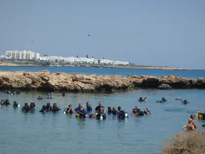a group of people swimming in the water at Green Bay Penthouse 2 in Protaras