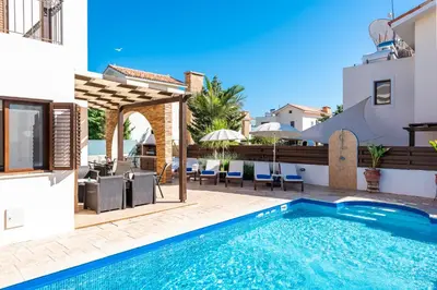 a villa with a swimming pool and a patio at Villa Iris by Ezoria Villas in Ayia Napa