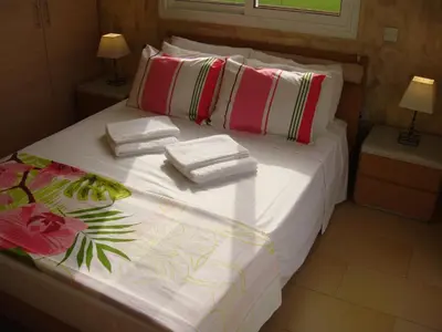 a bed with towels and pillows on top of it at Athena Villa in Ayia Napa