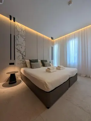 a bedroom with a large bed in a room at Tuck Inn in Larnaka