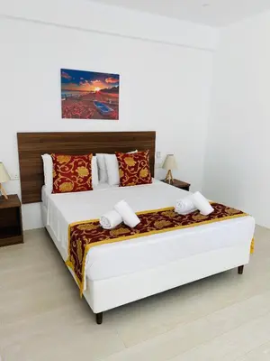 a bedroom with a large white bed in a room at Lysithea Hotel in Larnaka