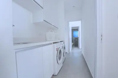 a white laundry room with a washer and dryer at White Pearl Villas in Protaras