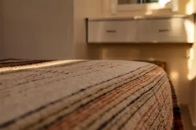 a bed with a blanket on top of it at Annita Court Bock B, Apt3 in Ayia Napa