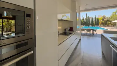 a kitchen with a view of a pool at Vivo Mare 3 Bedroom Villas in Ayia Napa