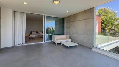 a balcony of a house with a couch and a table at Vivo Mare 3 Bedroom Villas in Ayia Napa