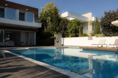 a swimming pool in front of a house at Vivo Mare 3 Bedroom Villas in Ayia Napa