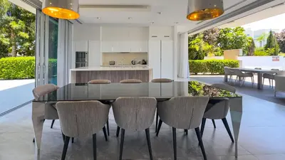 a kitchen and dining room with a glass table and chairs at Vivo Mare 3 Bedroom Villas in Ayia Napa