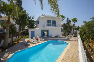 a villa with a swimming pool and a house at Villa Serene in Ayia Napa