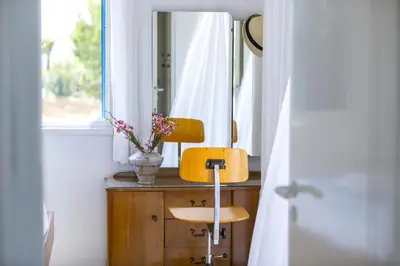 a chair in front of a mirror in a room at Villa Serene in Ayia Napa
