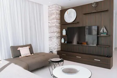 a living room with a couch and a flat screen tv at Vivo Mare Beachfornt Villas - Azure in Ayia Napa