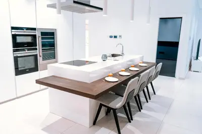 a kitchen with a long wooden table and chairs at Vivo Mare Beachfornt Villas - Azure in Ayia Napa