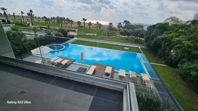 an overhead view of a swimming pool with chairs at Beachfront Luxury Villa Tranquility in Ayia Napa