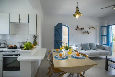 a kitchen and living room with a table with oranges on it at Protaras Ayios Elias Suite in Protaras