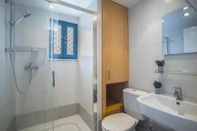 a bathroom with a shower and a toilet and a sink at Protaras Ayios Elias Suite in Protaras