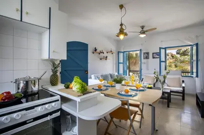 a kitchen and living room with a table and a tableablish at Protaras Ayios Elias Suite in Protaras
