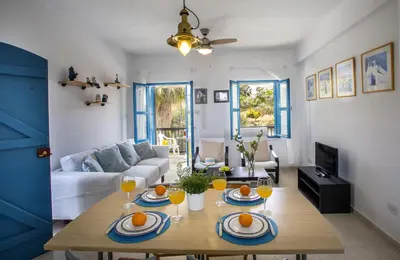 a living room with a table with oranges on it at Protaras Ayios Elias Suite in Protaras