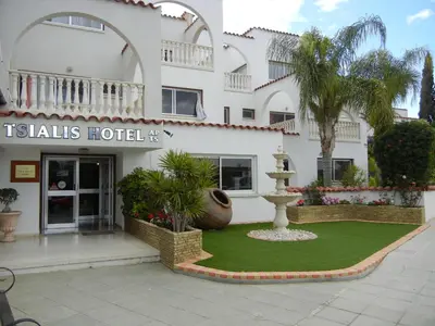 a hotel with a fountain in front of a building at Tsialis Hotel Apartments in Larnaka