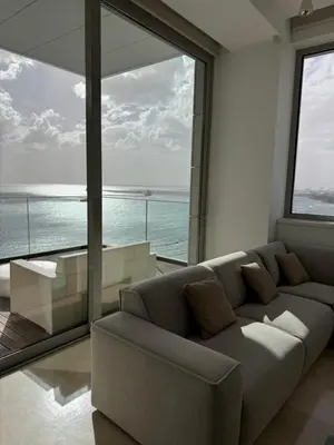 a living room with a couch and a large window at Olympic Residence Deluxe Apartments in Limassol