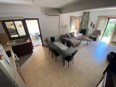 a living room with a table and a couch at Gold Mountain House in Moutoullas