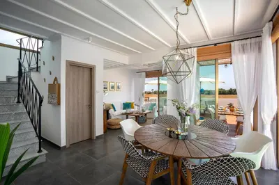 a dining room with a table and chairs at Chris Le Mare Luxury Villa in Protaras