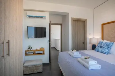 a bedroom with a bed and a tv on the wall at Chris Le Mare Luxury Villa in Protaras