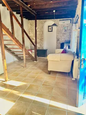 a living room with a couch and a staircase at Cornaro House in Arsos