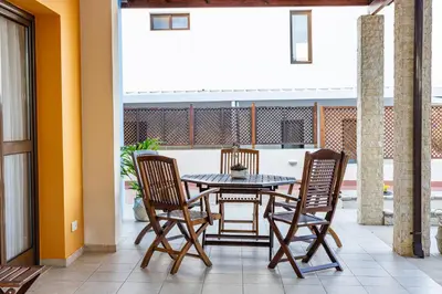 a patio with a table and chairs on a balcony at Villa Joan in Ayios Theodhoros