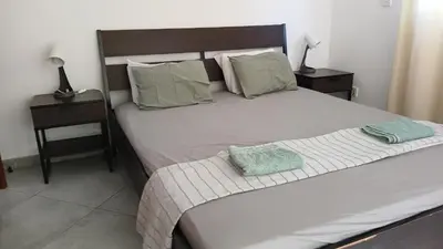 a bedroom with a bed and two nightstands and a bed sidx sidx sidx at Villa Kiveli in Ayia Napa