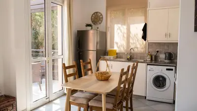 a kitchen with a table and chairs and a refrigerator at Villa Kiveli in Ayia Napa