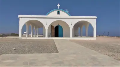 a small white church with a blue roof at Villa Kiveli in Ayia Napa