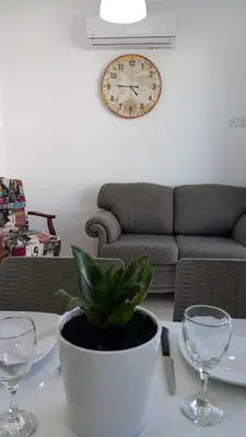 a plant in a pot on a table with glasses at CHRIS'S HOLIDAY APT - AYIA NAPA in Ayia Napa