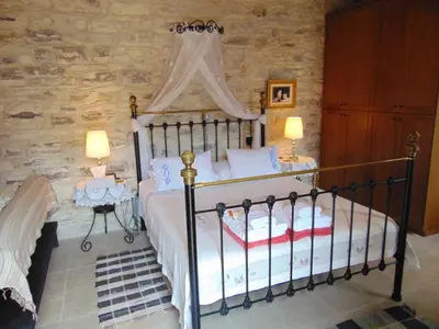 a bedroom with a bed with a canopy at Charalambos Holiday Cottage in Kalavasos