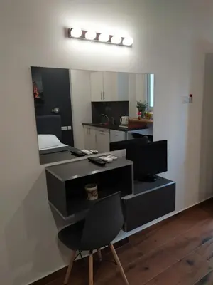 a room with a desk with a chair and a mirror at Takis apartments in Ayia Napa