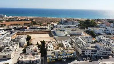 an aerial view of a city with the ocean at Sylvias art studio apt in Ayia Napa