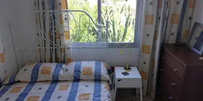 a bedroom with a bed and a window at Family Nest In The Heart Of Limassol in Limassol