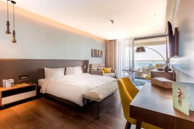 a hotel room with a bed and a living room at Radisson Blu Hotel, Larnaca in Larnaka