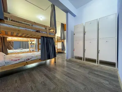 a room with two bunk beds and cabinets at House of Nissus Hostel in Ayia Napa