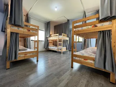 a room with three bunk beds in it at House of Nissus Hostel in Ayia Napa