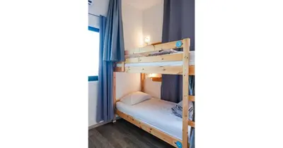a bedroom with two bunk beds in a room at House of Nissus Hostel in Ayia Napa