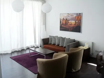 a living room with a couch and a table and chairs at The Kapitani Residence in Nicosia