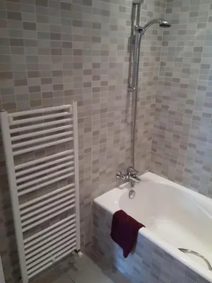 a bathroom with a bath tub with a towel on it at The Kapitani Residence in Nicosia