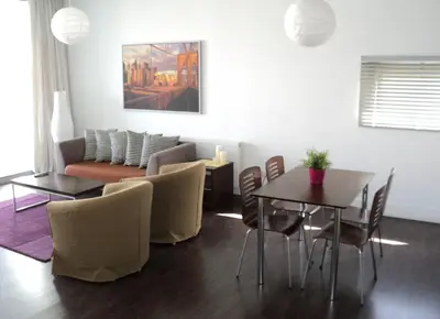 a living room with a couch and a table and chairs at The Kapitani Residence in Nicosia