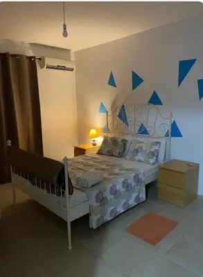 a bedroom with a bed with blue stars on the wall at Tranquil Country Condo - Tersefanou in Larnaka