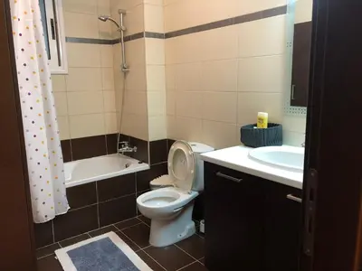 a bathroom with a toilet and a sink and a tub at Tranquil Country Condo - Tersefanou in Larnaka