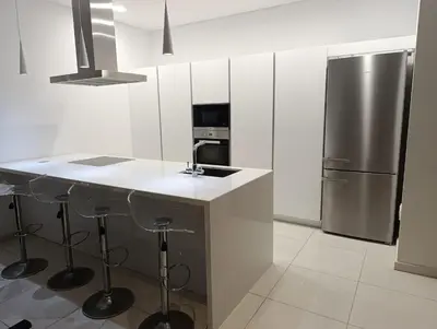 a kitchen with a counter and a stainless steel refrigerator at Beachfront Luxury Villa Glory in Ayia Napa