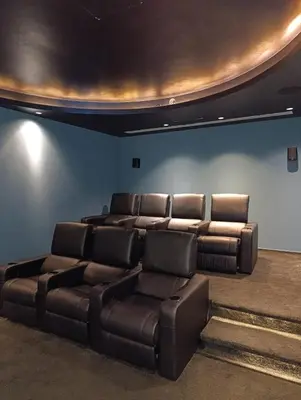 a living room with a leather couch and chairs at Beachfront Luxury Villa Glory in Ayia Napa
